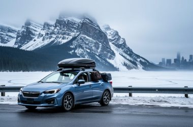 “A car parked at a Canadian roadside pull-off facing a snowy mountain pass with pine forest and a distant skyline under an overcast sky.”