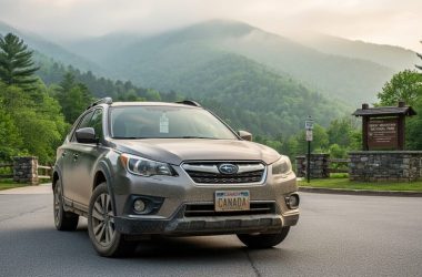 Vehicle parked near the Great Smoky Mountains entrance with a physical parking tag displayed in the windshield, with misty evergreen mountains in the background.
